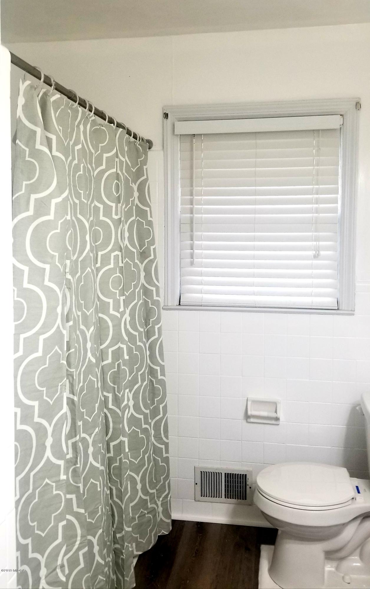 2718 Allen Road Macon, GA 31216 - Photo 7 of 12 a bathroom with a toilet and a shower curtain
