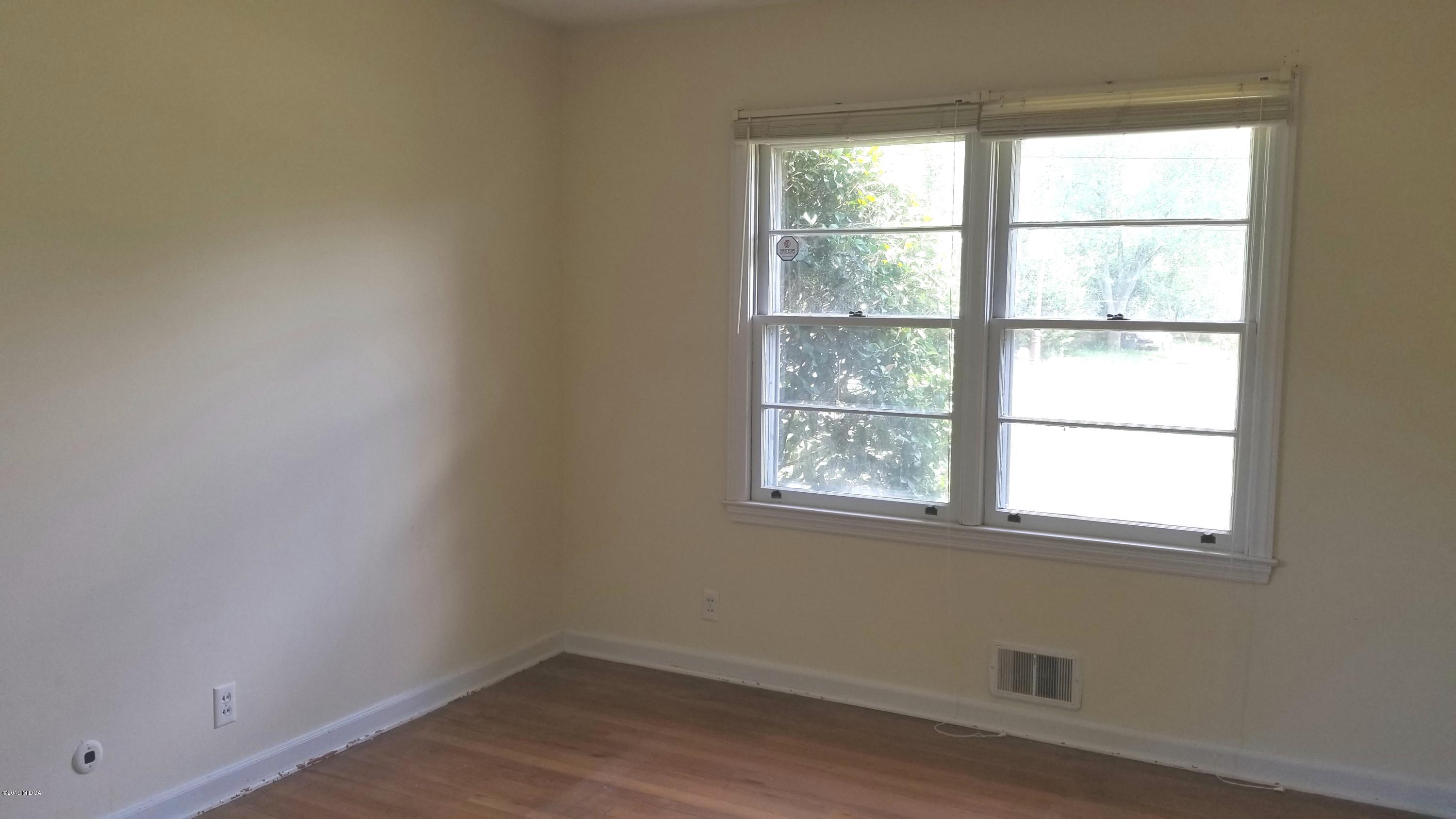 2718 Allen Road Macon, GA 31216 - Photo 8 of 12 an empty room with a window