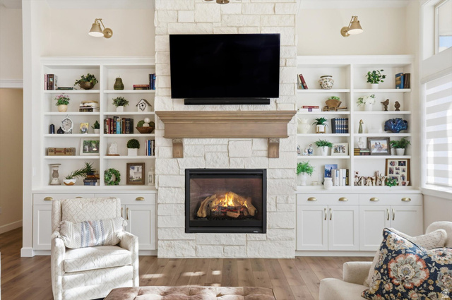 534 East Fish Hatchery Road Mantua, UT 84324 - Photo 7 of 87 Living room featuring a fireplace, wood finished floors, built in shelves, and plenty of natural light
