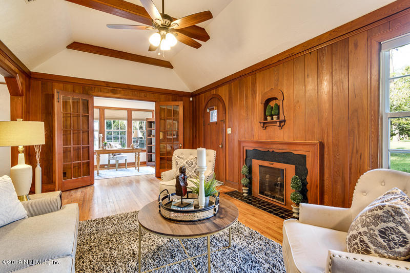 3827 Gadsden Road Jacksonville, FL 32207 - Photo 7 of 25 a living room with furniture a fireplace and a large window