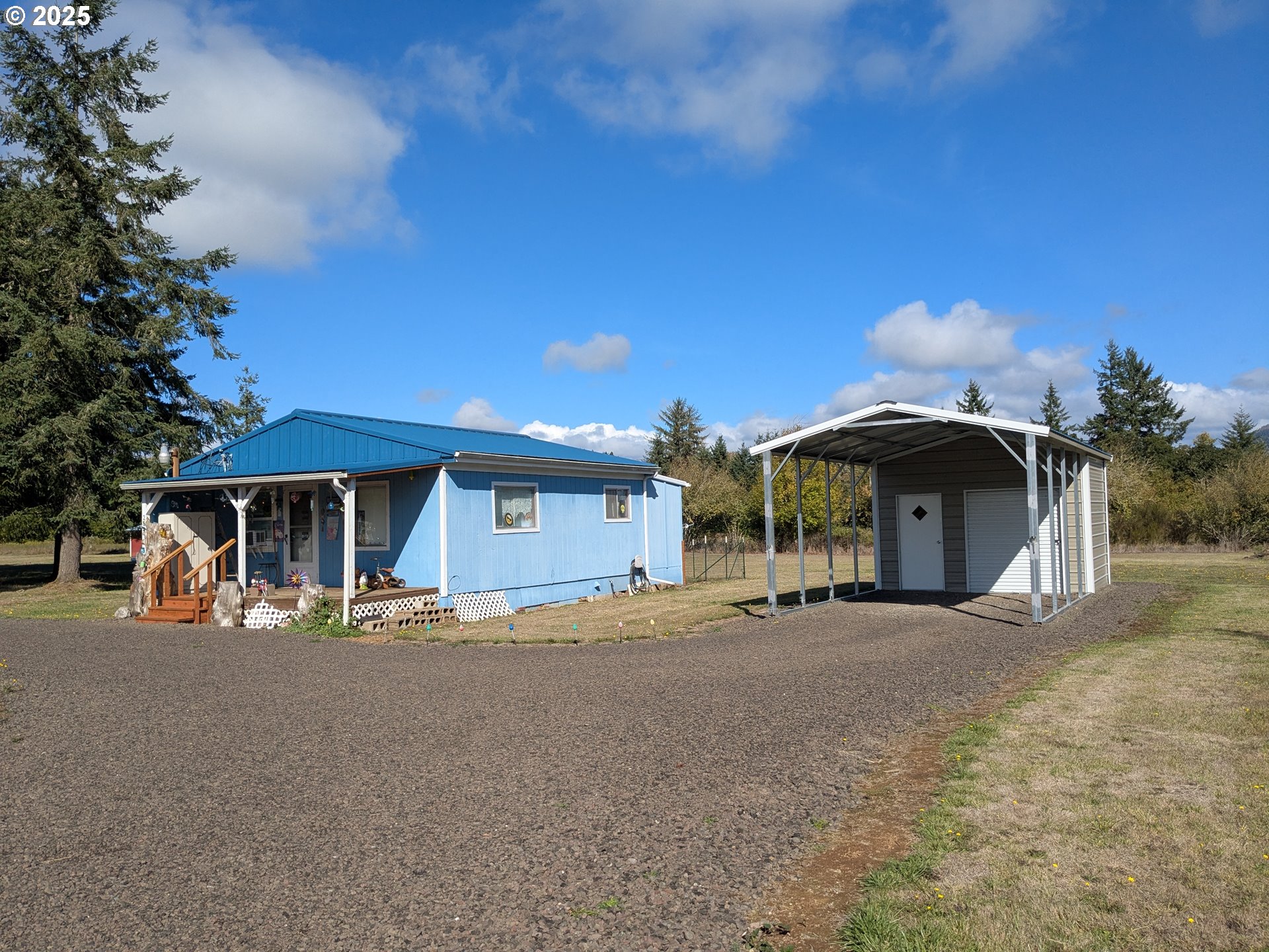 28475 Andy Riggs Road Grand Ronde, OR 97347 - Photo 1 of 15 a view of a house with large trees and a barn