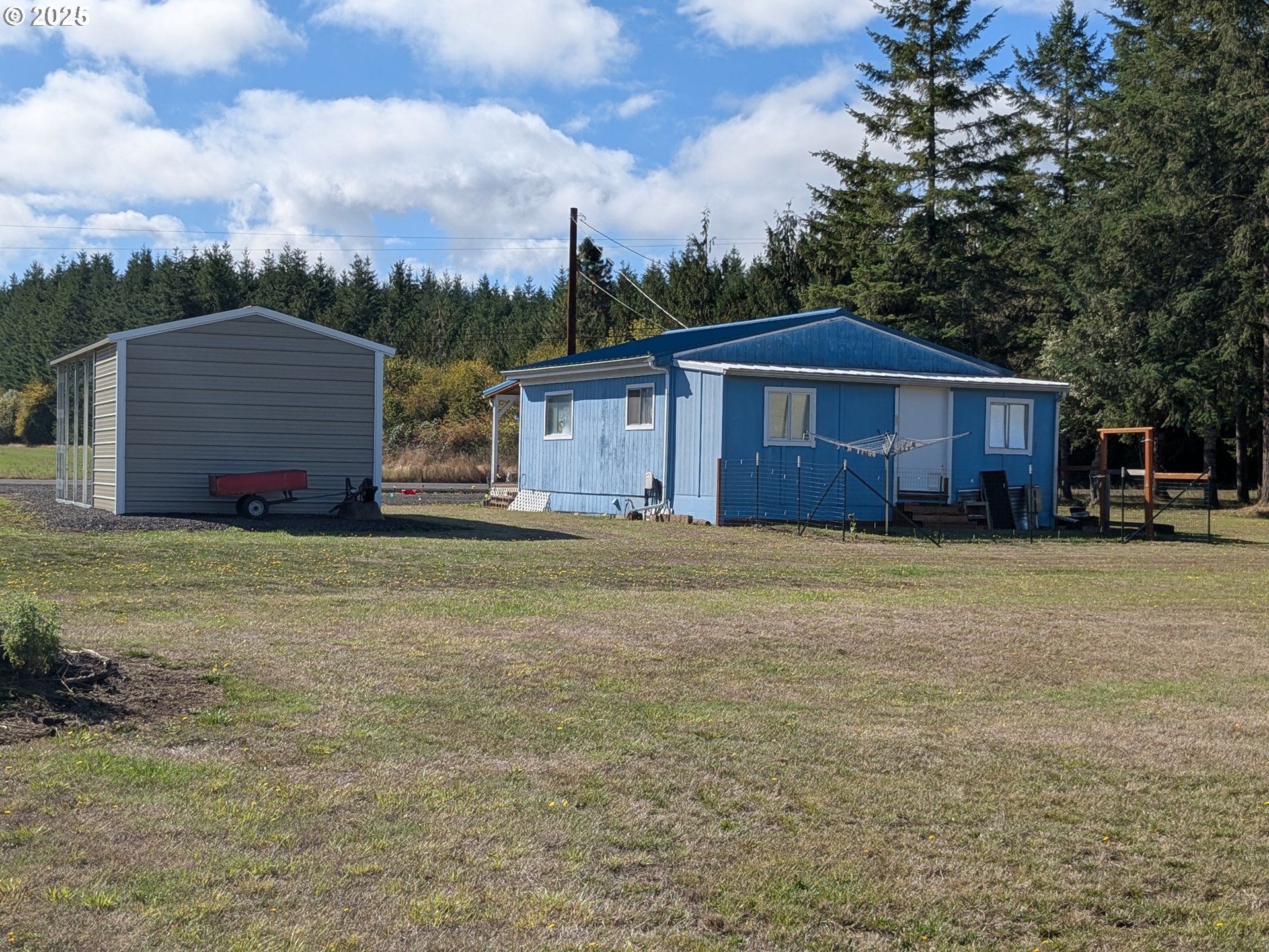 28475 Andy Riggs Road Grand Ronde, OR 97347 - Photo 15 of 15 a front view of a house with a garden and trees