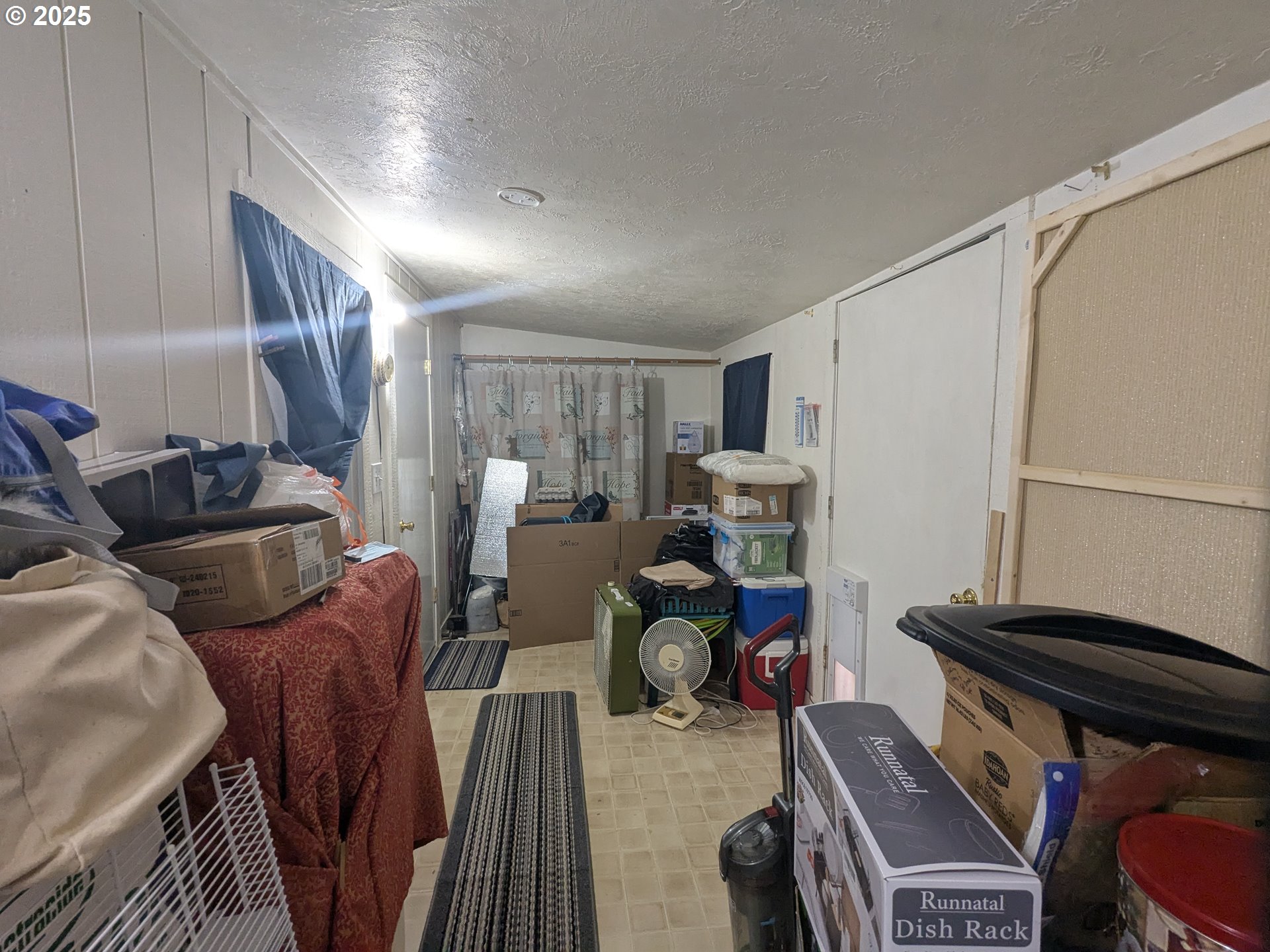 28475 Andy Riggs Road Grand Ronde, OR 97347 - Photo 9 of 15 a living room with furniture a flat screen tv and a window