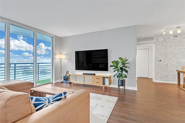 a living room with furniture and a flat screen tv
