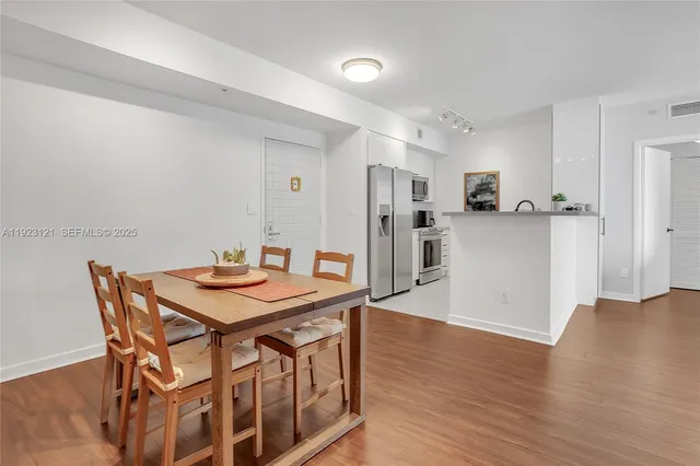 a view of a dining room with furniture and wooden floor