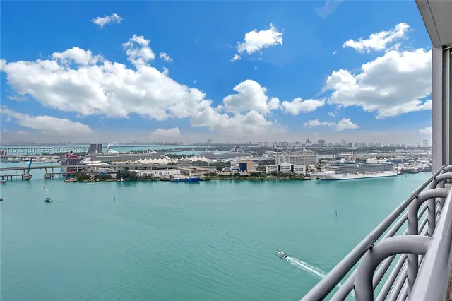 an aerial view of a residential houses with outdoor space and ocean view