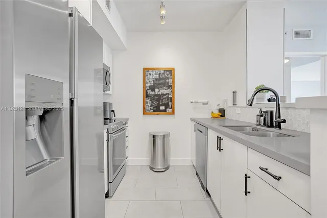 a kitchen with a refrigerator and sink