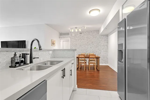 a kitchen with a sink cabinets and outdoor space