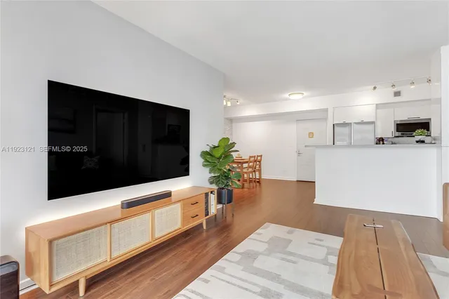 a kitchen with stainless steel appliances kitchen island sink stove and cabinets