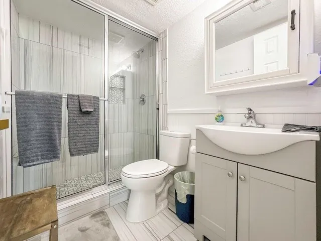 a bathroom with a sink toilet and shower