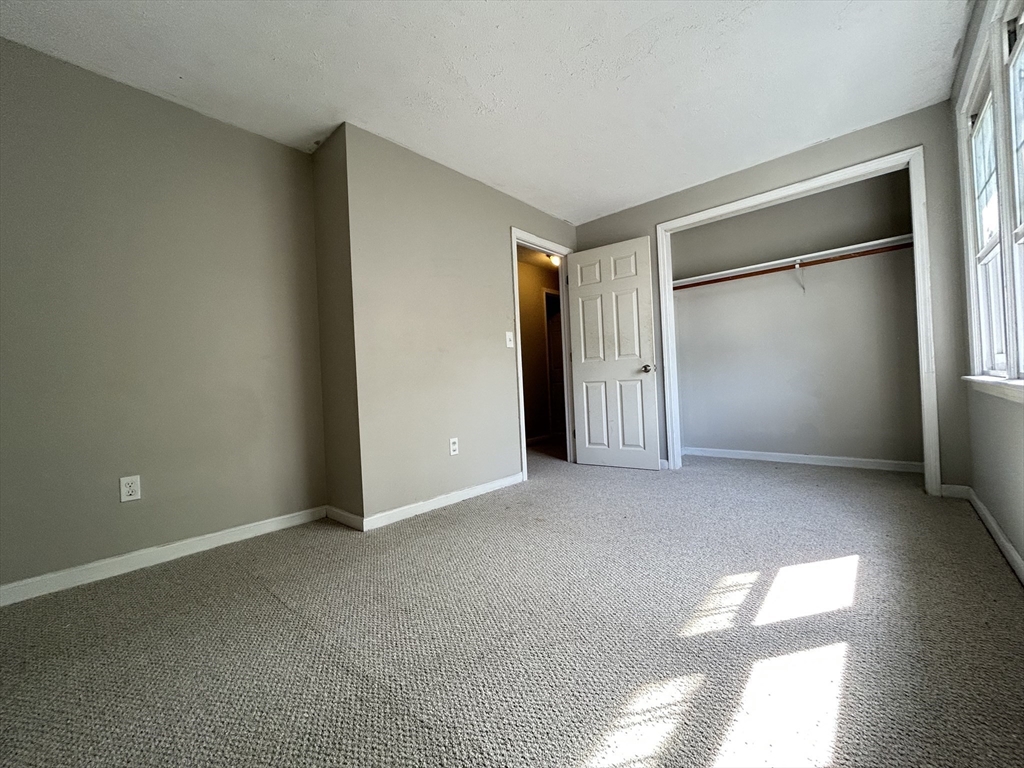 266 Massasoit Road Worcester, MA 01604 - Photo 18 of 26 an empty room with closet and windows
