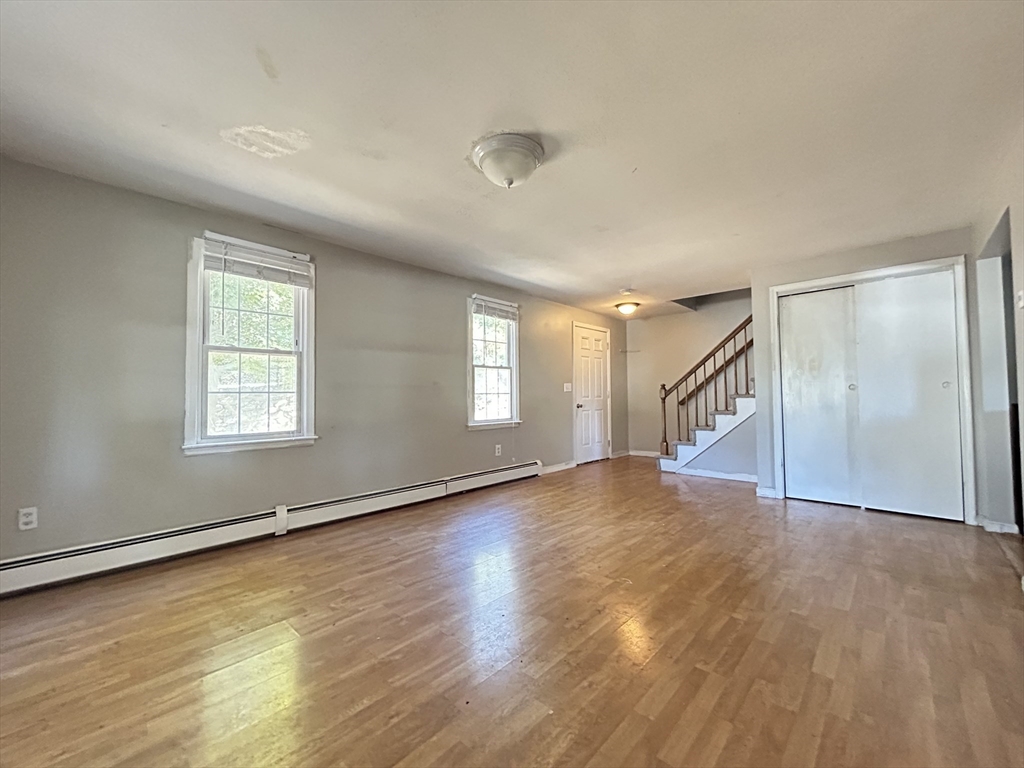 266 Massasoit Road Worcester, MA 01604 - Photo 23 of 26 an empty room with wooden floor and windows