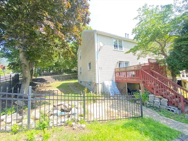 a view of a house with backyard and sitting area