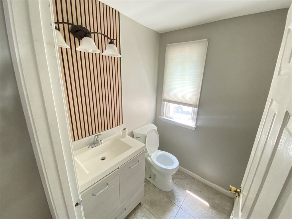 266 Massasoit Road Worcester, MA 01604 - Photo 3 of 26 a bathroom with a sink toilet and window