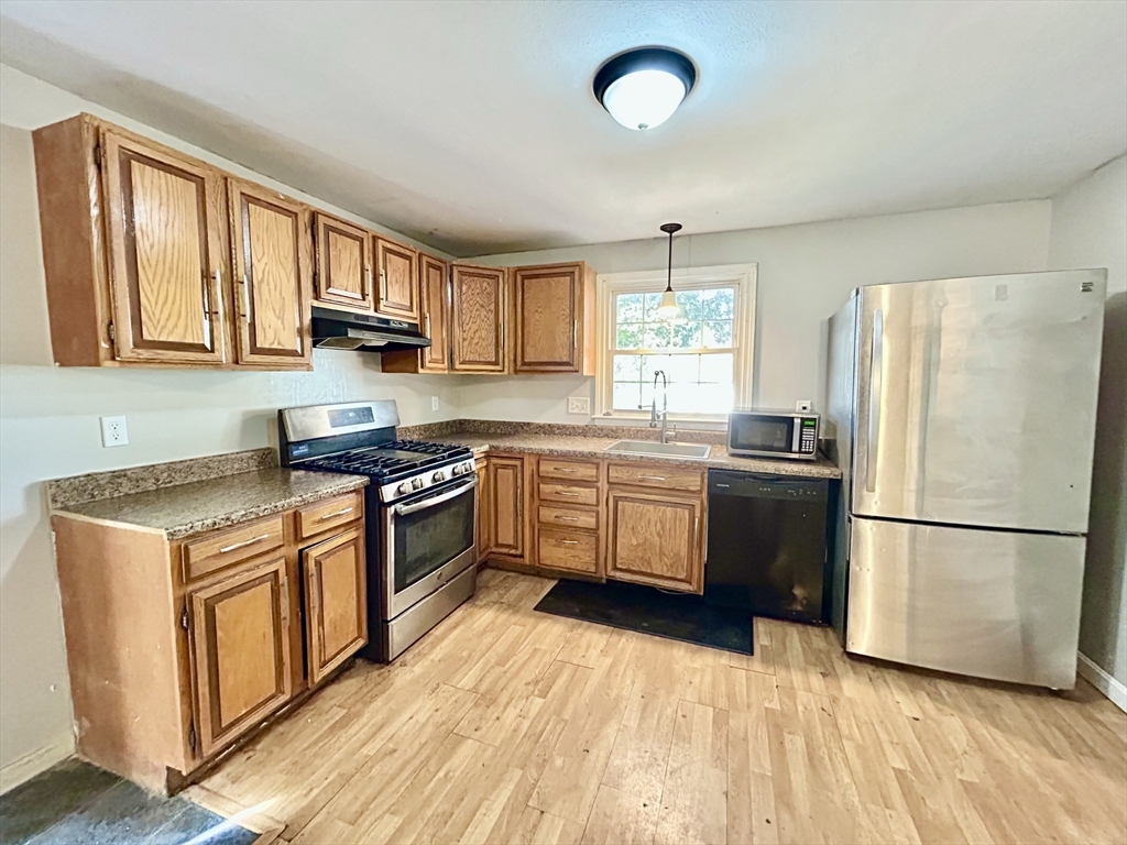 266 Massasoit Road Worcester, MA 01604 - Photo 4 of 26 a kitchen with stainless steel appliances granite countertop a stove a sink dishwasher a refrigerator and a stove