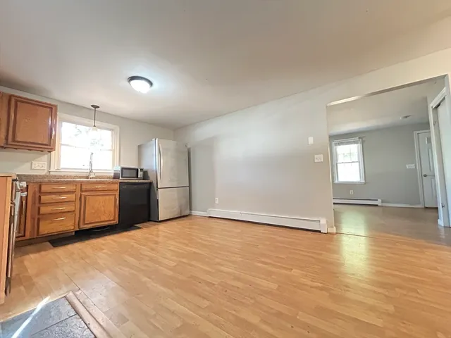 a view of a kitchen with a sink a stove top oven and cabinets
