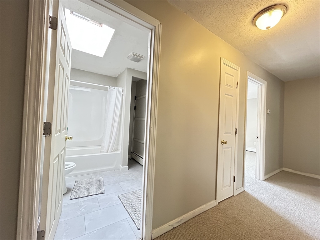 266 Massasoit Road Worcester, MA 01604 - Photo 10 of 26 a view of a bathroom with a tub and shower