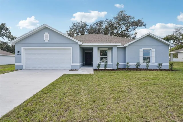 a front view of house with yard and outdoor seating