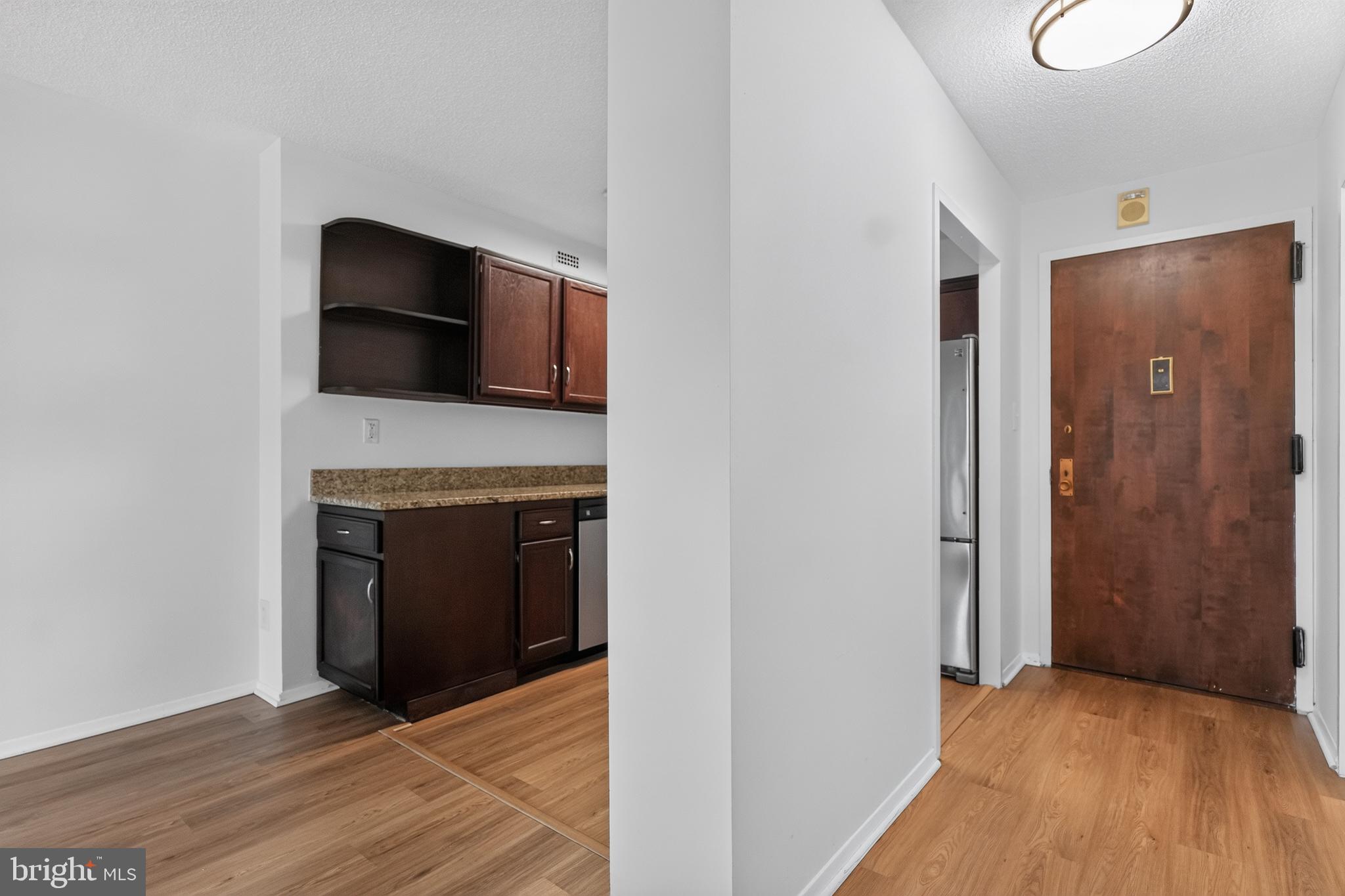 5225 Pooks Hill Road, Unit 1302N Bethesda, MD 20814 - Photo 11 of 19 a view of an empty room with wooden floor and a fireplace