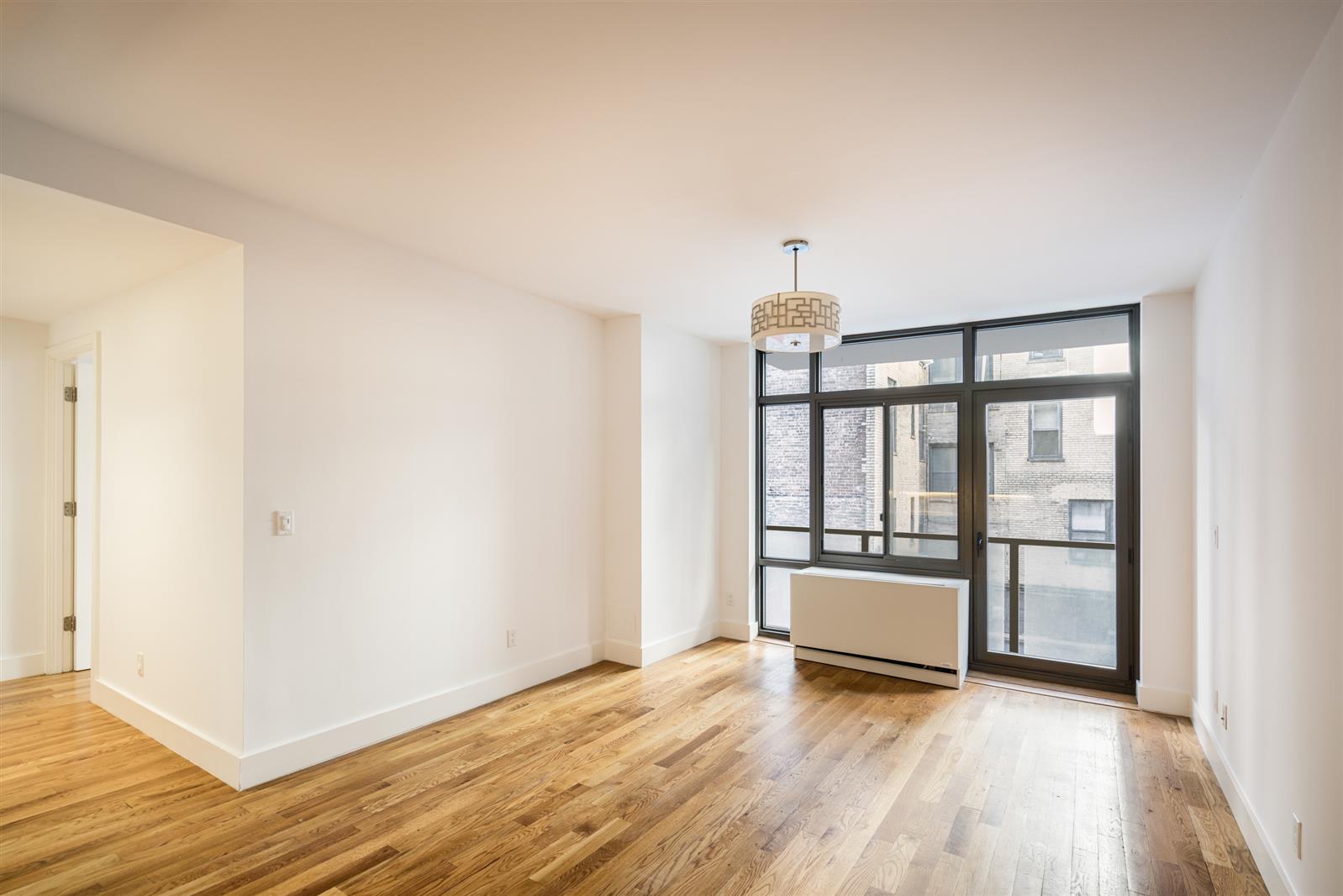 33 Caton Place, Unit 5H Brooklyn, NY 11218 - Photo 4 of 10 a view of a room with wooden floor and front door