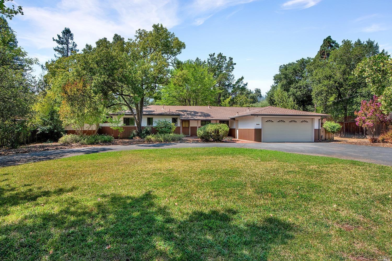 3435 Wallace Road Santa Rosa, CA 95404 - Photo 1 of 1 a front view of house with yard and trees in the background