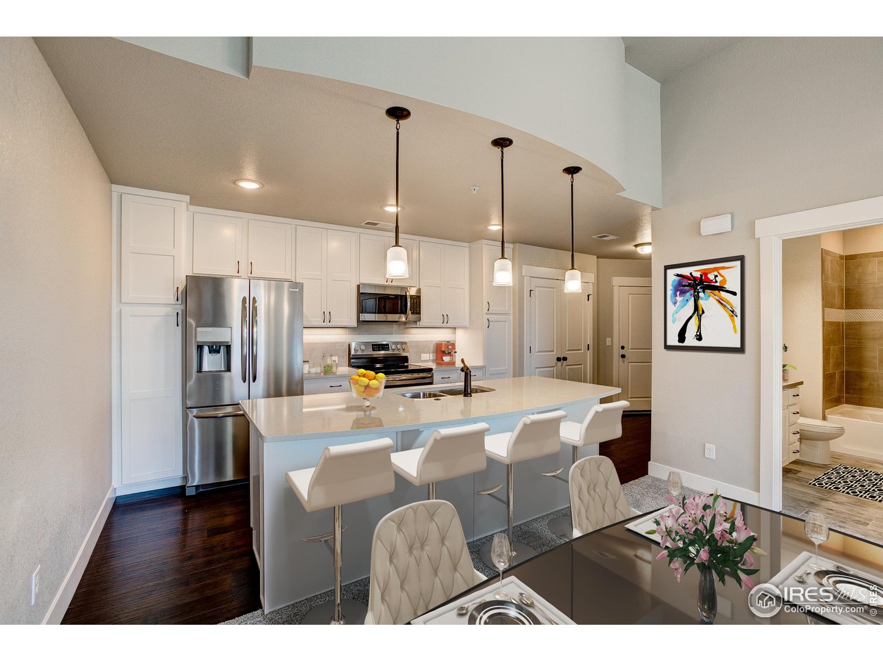 975 Landmark Way, Unit 11 Fort Collins, CO 80524 - Photo 2 of 16 a kitchen with stainless steel appliances kitchen island granite countertop a refrigerator a stove top oven a sink and dishwasher