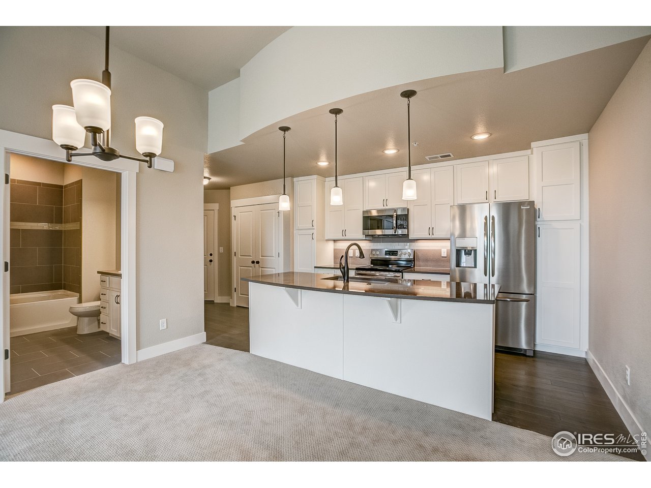 975 Landmark Way, Unit 11 Fort Collins, CO 80524 - Photo 4 of 16 a kitchen with stainless steel appliances kitchen island a refrigerator and a sink