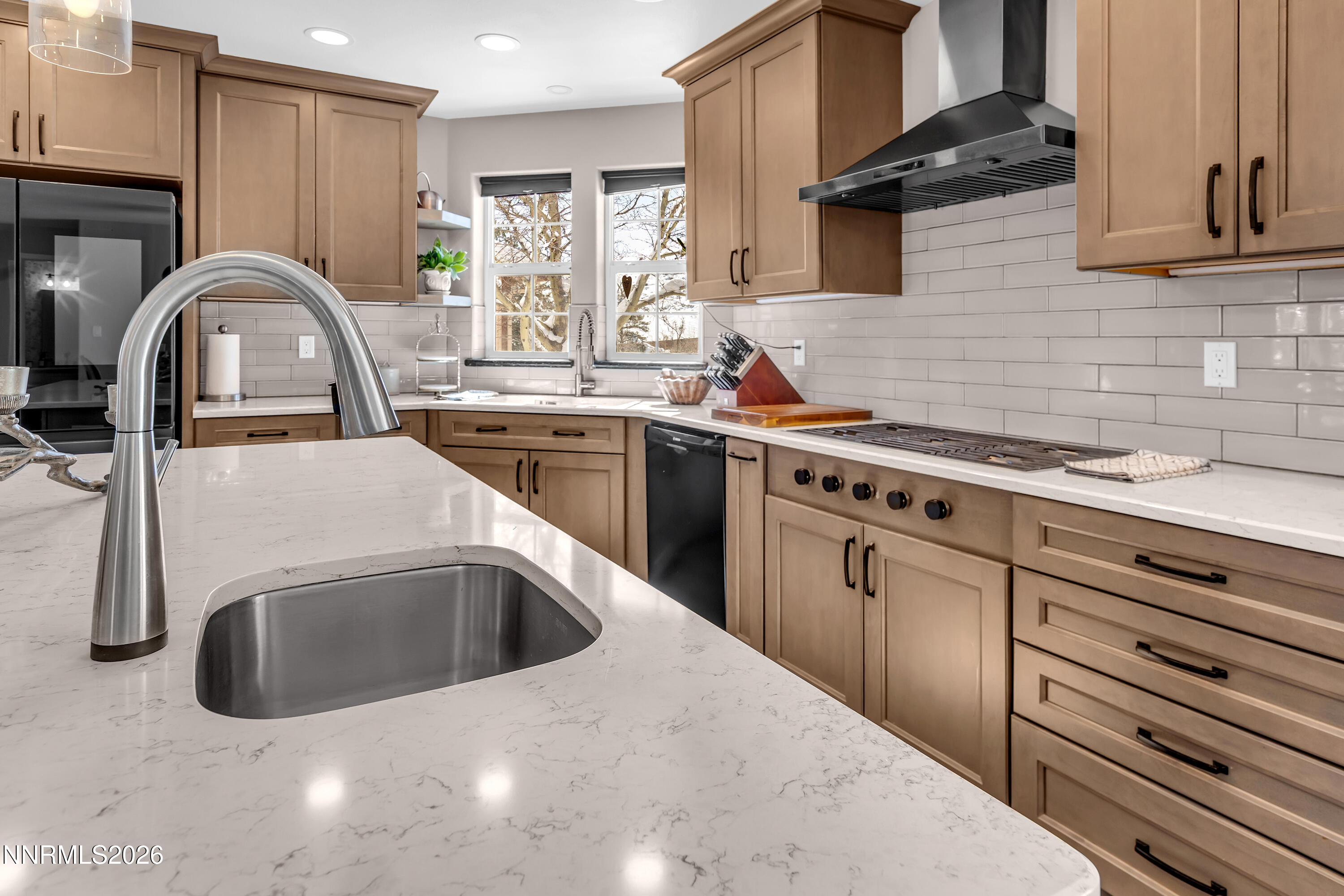 2677 Chaparral Drive Reno, NV 89509 - Photo 15 of 35 a kitchen with stainless steel appliances granite countertop a sink a stove and a wooden cabinets