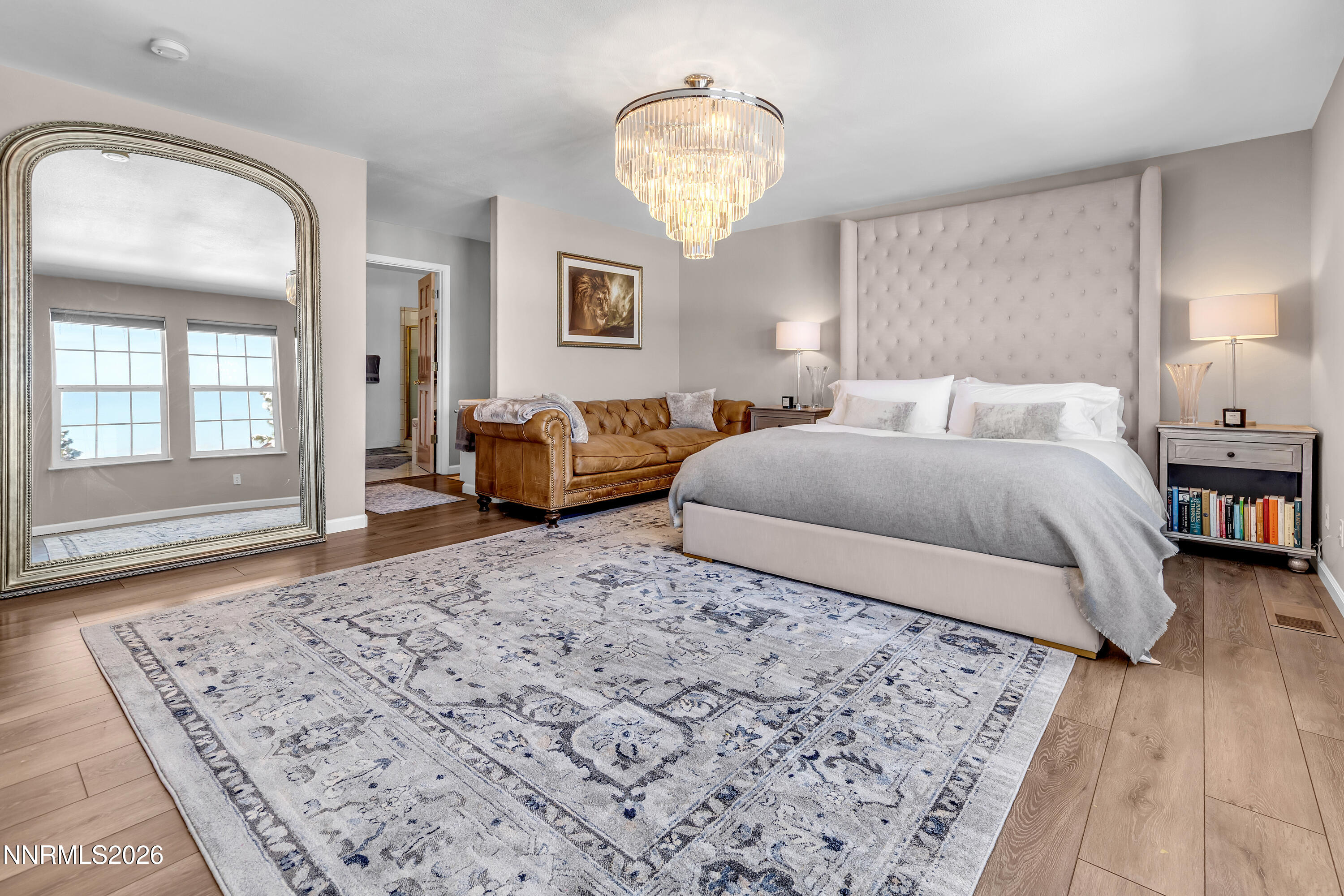 2677 Chaparral Drive Reno, NV 89509 - Photo 17 of 35 a bedroom with a large bed and a chandelier