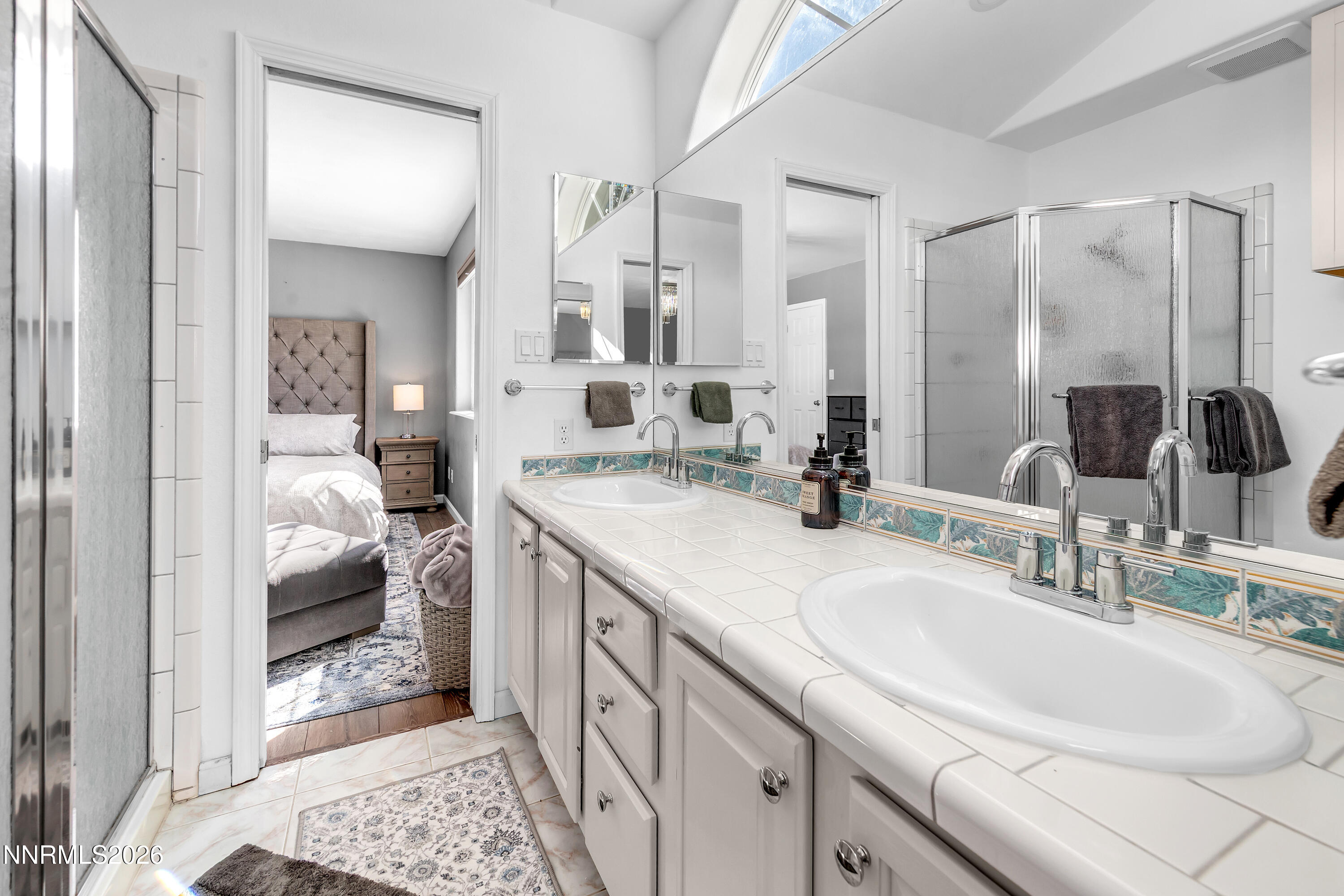 2677 Chaparral Drive Reno, NV 89509 - Photo 21 of 35 a en suite bathroom with double sink and a mirror