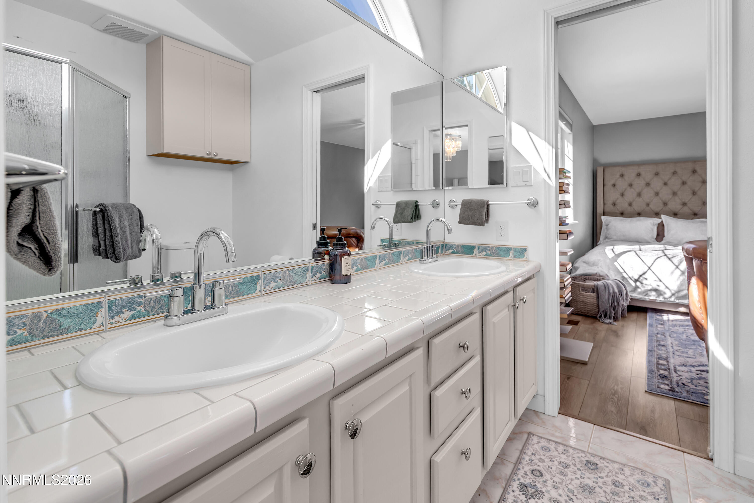 2677 Chaparral Drive Reno, NV 89509 - Photo 22 of 35 a en suite bathroom with double sink and a mirror