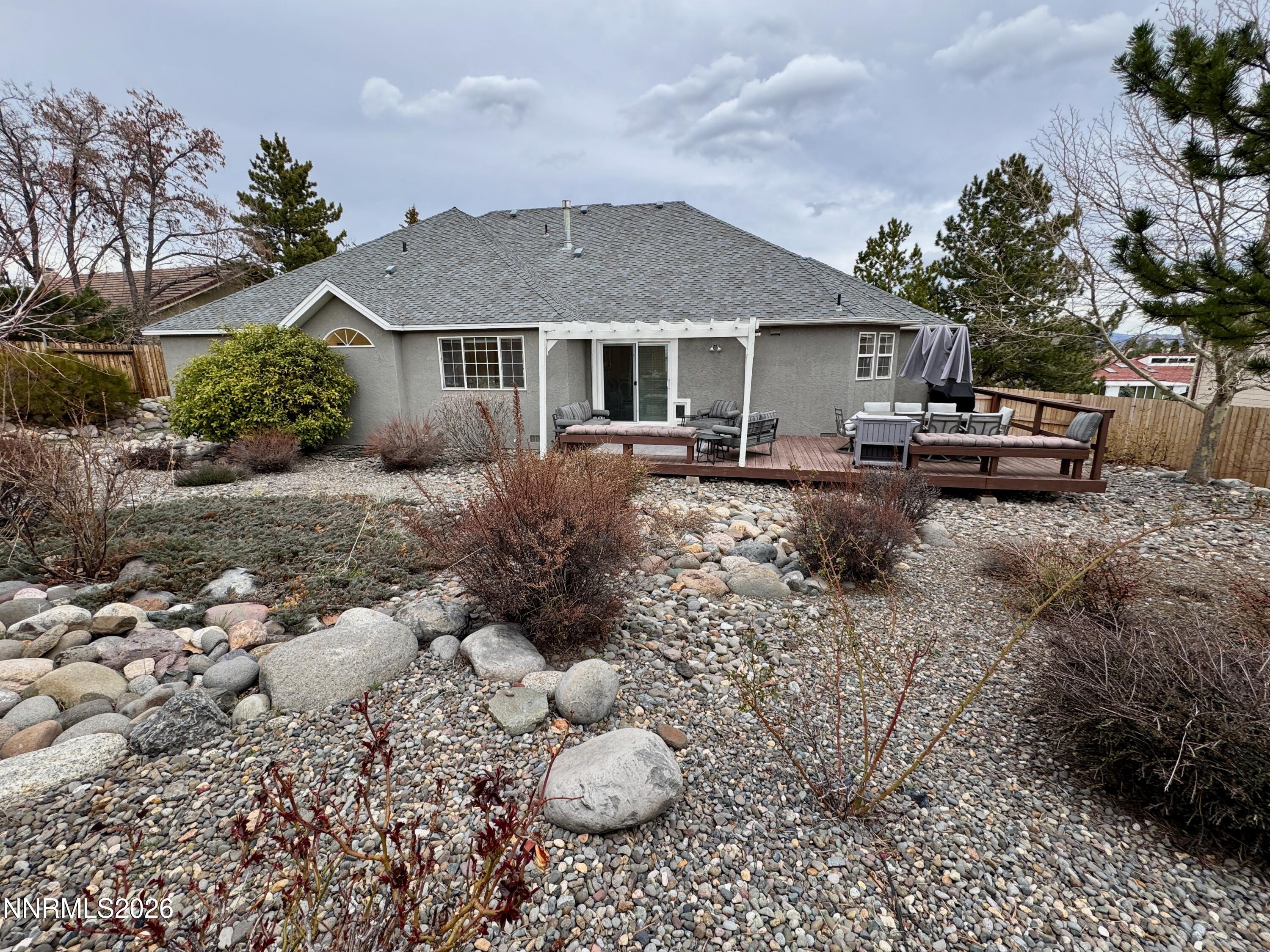 2677 Chaparral Drive Reno, NV 89509 - Photo 26 of 35 a front view of a house with a yard fire pit and outdoor seating