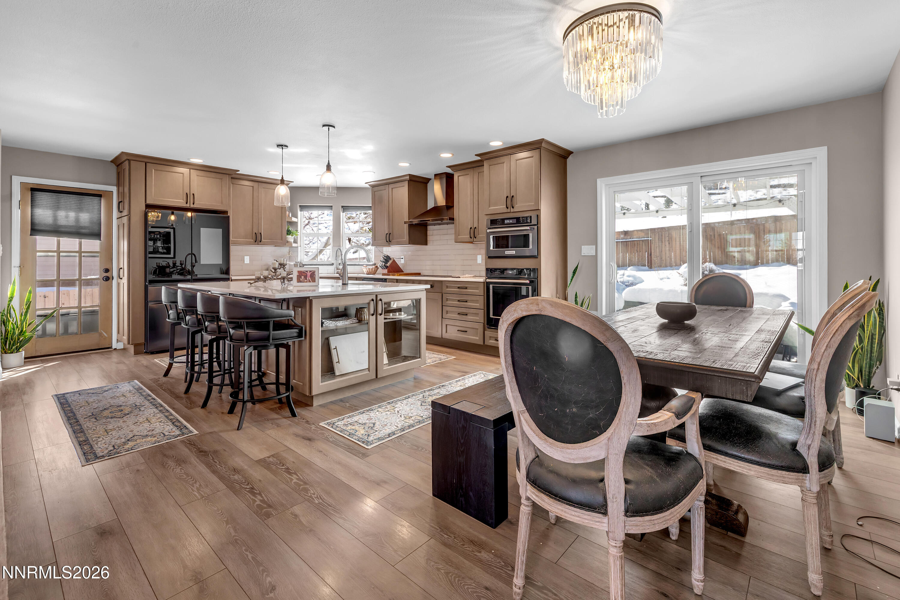 2677 Chaparral Drive Reno, NV 89509 - Photo 9 of 35 a kitchen with stainless steel appliances a dining table chairs a stove and a refrigerator