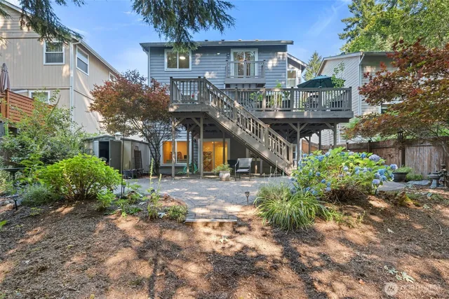 a front view of a house with a yard and potted plants