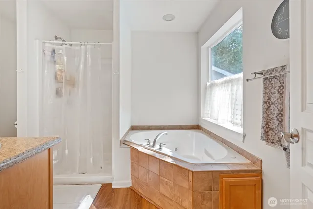 a bathroom with a tub sink and window