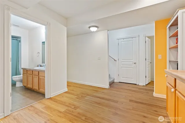 a view of a room with wooden floor