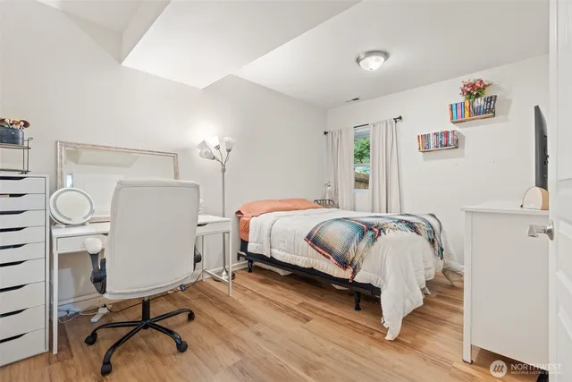 a bedroom with a bed and a desk