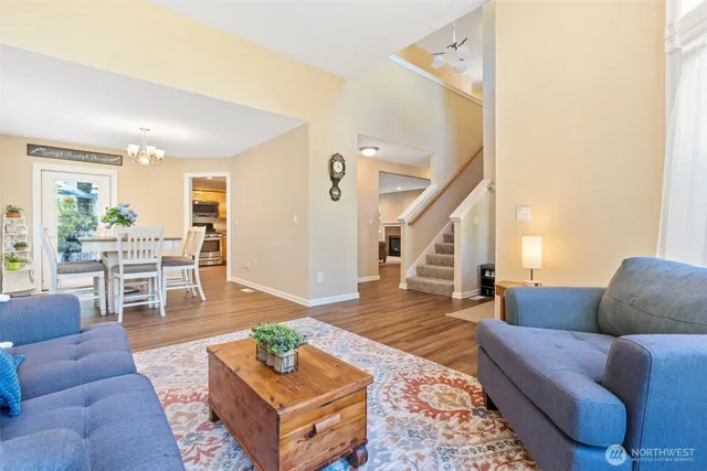 a living room with furniture and a dining table