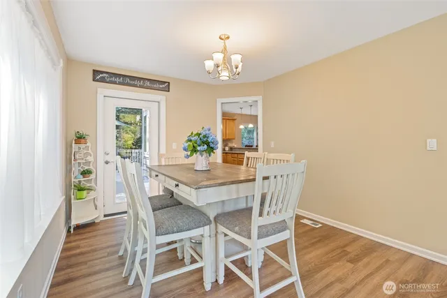 a view of a dining room with furniture and chandelier