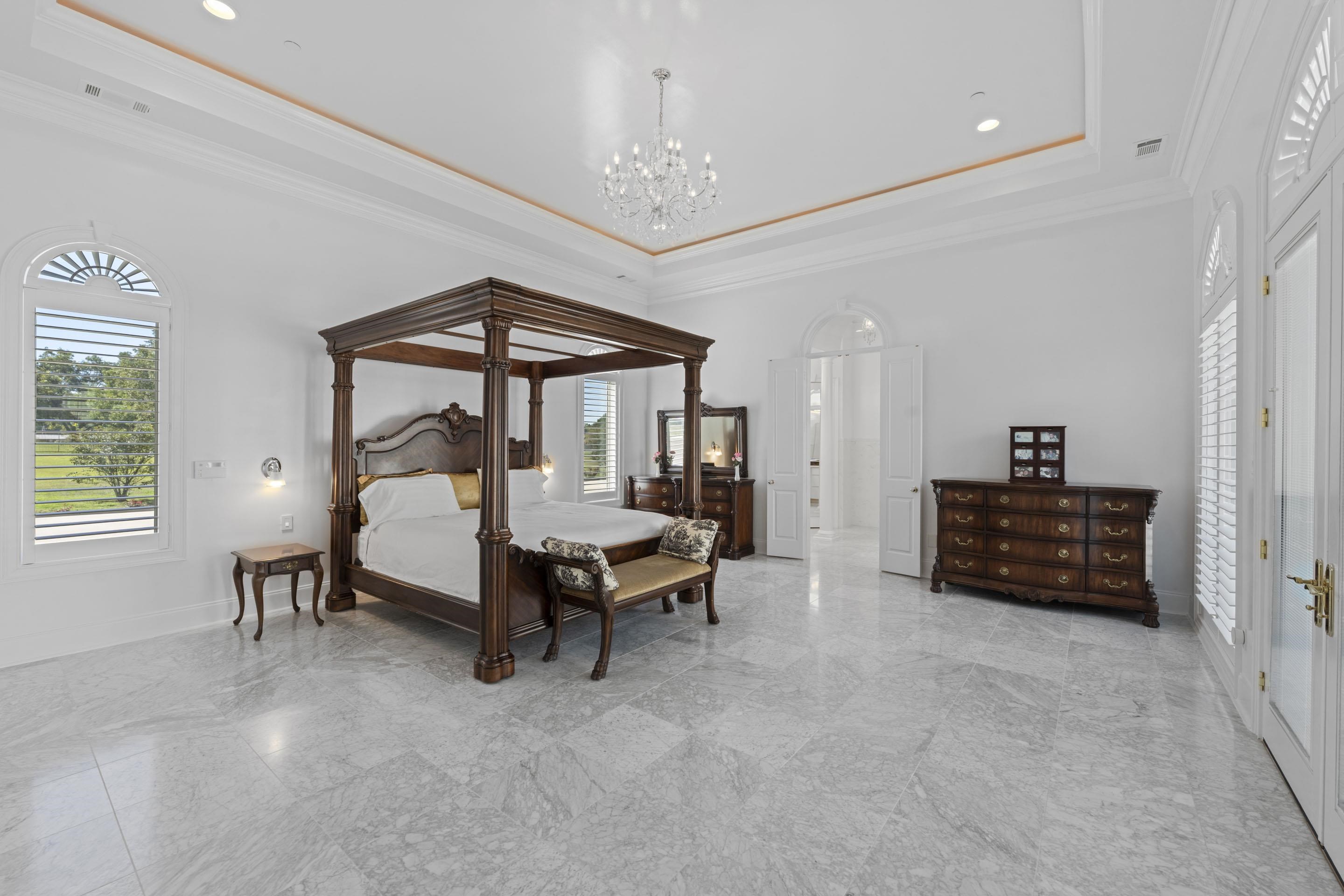 881 Bray Station Road Collierville, TN 38017 - Photo 19 of 40 Bedroom with a raised ceiling, ornamental molding, a chandelier, light marble finish flooring, and recessed lighting