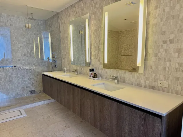 a bathroom with a double vanity sink and a mirror