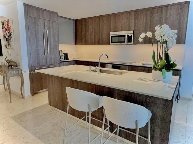 a kitchen with a table chairs and a refrigerator
