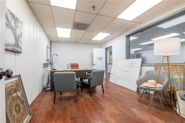 a living room with furniture a dining table and wooden floor