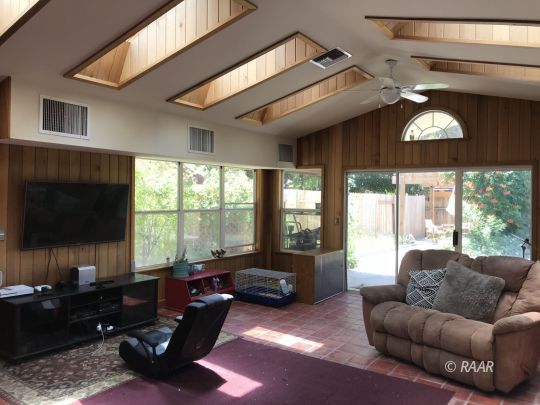 1009 Meadowview Lane Ridgecrest, CA 93555 - Photo 15 of 32 a living room with furniture and a flat screen tv