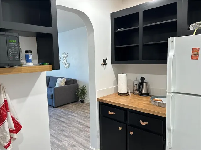 a kitchen with a refrigerator and a sink
