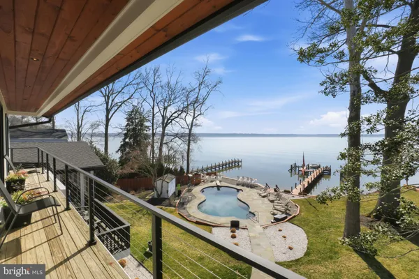 an aerial view of a house with a yard and mountain view in back