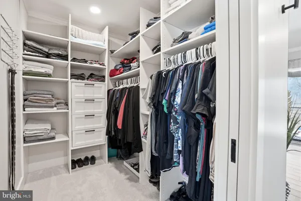a kitchen with kitchen island stainless steel appliances a sink stove and refrigerator