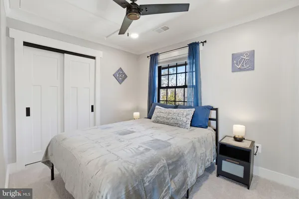 a living room with furniture a ceiling fan and a rug