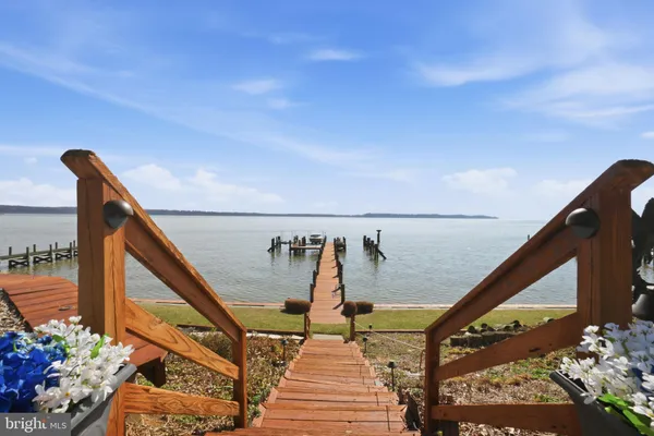 a view of a house with pool and chairs
