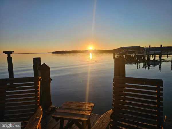 a view of a swimming pool with outdoor seating